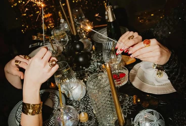 Sparklers and champagne glasses on a candlelit celebration table